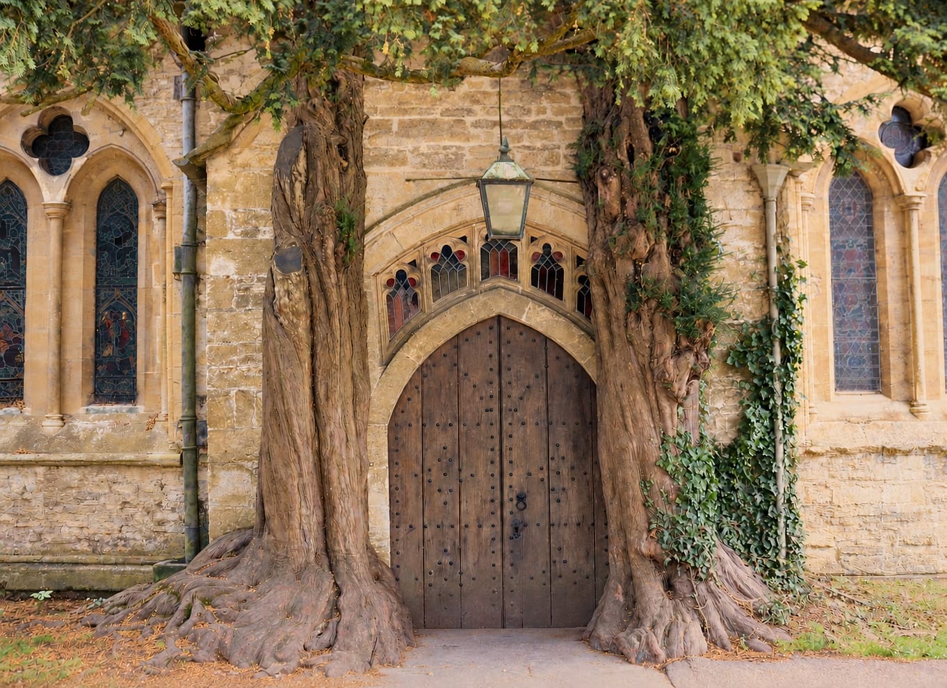 The north doorway of St Edward’s Church framed by yew trees in Stow-on-the-Wold